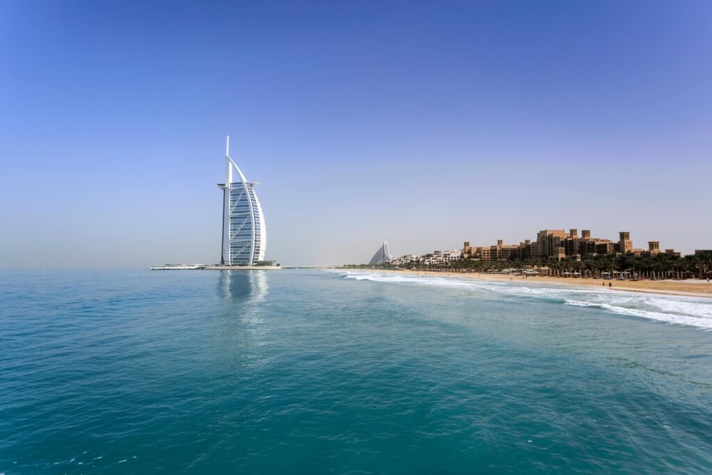 Iconic Burj Al Arab overlooking the pristine Dubai beach, perfect for travel and leisure.